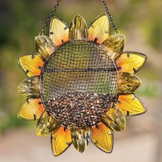 a sunflower shaped bird feeder hanging from a chain