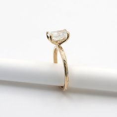 a yellow gold ring with a single diamond