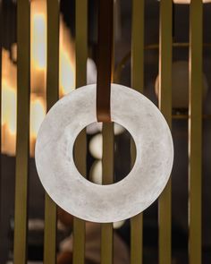 a white circular object hanging from a metal rod