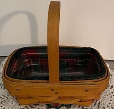 a wooden basket sitting on top of a white doily