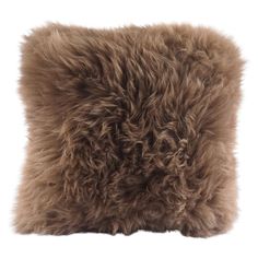 a brown furry pillow sitting on top of a white floor