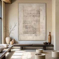 a living room filled with furniture and a painting on top of a wooden table in front of a window