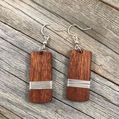 wooden earrings with silver lines on them