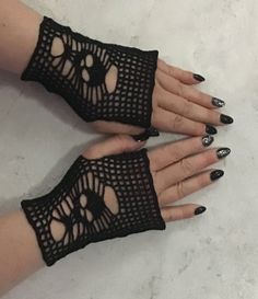 two women's hands wearing black lace gloves