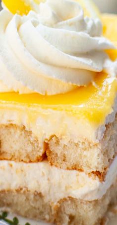 a piece of cake with whipped cream and lemon on top