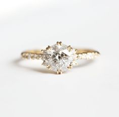 a diamond engagement ring on a white background