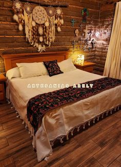 a large bed sitting inside of a bedroom on top of a wooden floor next to a window