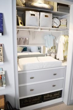 an organized closet with white drawers and baby changing table