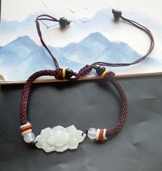 "Weave Rope lotus flower Natural Burmese jadeite jade,stone bead bracelet,Grade A,amulet,protector,mood,good lucky gift,gemstone,Yoga Jewelry material: natural jadeite jade stone,rope  Size:  flower : approx. 15mmx28mmx5mm Rope Color: brown color length:6\"-9\" style: weave rope,adjustable bracelet Price: one bracelet ❤ If you want other length Bracelet, Please connect me free. ❤Please read the store policy before purchase. ❤ Thank you for visiting my shop!" Spiritual Jade Bracelets For Good Luck, Good Luck Jade Bracelets Spiritual Style, White Jade Jewelry For Meditation, White Spiritual Bracelet For Good Luck, Spiritual White Bracelets For Good Luck, Spiritual White Bracelet For Good Luck, Traditional White Jewelry For Good Luck, White Traditional Good Luck Jewelry, White Jade Bracelets For Meditation