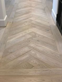 an empty kitchen with wood flooring and white walls