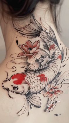 the back of a woman's neck with a koi fish tattoo on it