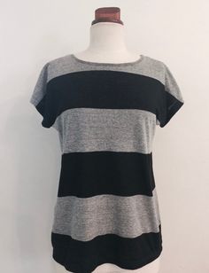 Women's summer black and grey knit tee shirt with wide stripes.  The shirt has  cap sleeves.  This top is handmade.    The  soft knit fabric is easy care.  It is a great travel shirt because it is washable and packable.  This tee shirt  is comfortable rayon knit.  It is versatile can be worn with pants or a skirt, to work or school, or for travel.  It comes in sizes Small through XL. Black And Grey Striped Shirt, Black Travel Dress, Skirt To Work, Chris Afton, Black And Grey Sleeve, Grey Striped Shirt, Striped Tops Women, Travel Shirt, Stripe Tee