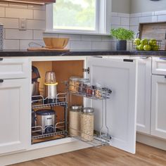 an open cabinet in the middle of a kitchen