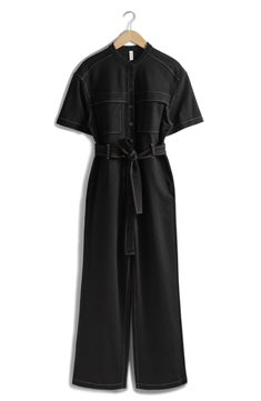 Contrast stitching amplifies the utilitarian vibes of a wide-leg jumpsuit tied with a matching belt. 30" inseam, 20" leg opening, 56" length (size Small) Front button closure Band collar Short sleeves Front patch pockets; side-seam pockets Removable tie belt 73% viscose, 23% polyamide, 4% elastane Dry clean Imported Chic Workwear Jumpsuits And Rompers With Belt Loops, Utility Jumpsuits And Rompers For Workwear, Short Sleeve Denim Utility Jumpsuit For Workwear, Utility Style Denim Jumpsuit With Short Sleeves For Work, Fitted Belted Jumpsuits And Rompers For Work, Chic Workwear Jumpsuits And Rompers With Belted Cuffs, Belted Wide-leg Jumpsuit For Work, Belted Wide Leg Jumpsuits For Work, Wide-leg Belted Jumpsuit For Work