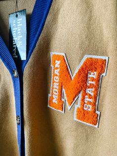 Make a bold statement and wear your Morgan State pride with this one-of-a-kind and comfortable cardigan sweater, perfect for any alumni, students or supporters. Made with the highest quality materials, this sweater is designed to keep you warm and cozy while representing Morgan State. Features:- Official Morgan State University logo embroidered on the chest- Large "M" Chenille patch- Classic cardigan design with a tortoise shell button-up front- Two front pockets (deep enough to fit a phone and Morgan State University, Varsity Cardigan, Chenille Patch, Cardigan Design, University Logo, Classic Cardigan, Black Community, Black Excellence, Sweater Making