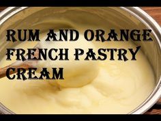 a metal bowl filled with cream and a wooden spoon in it that says rum and orange french pastry cream