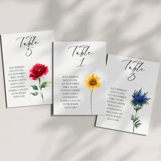 three cards with flowers on them and the names of each card