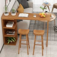 a small table with two stools in front of it and a couch behind it