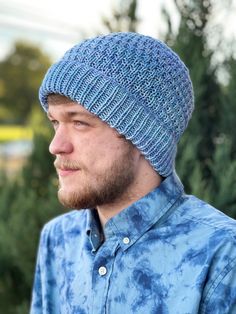 a man wearing a blue tie dye hat