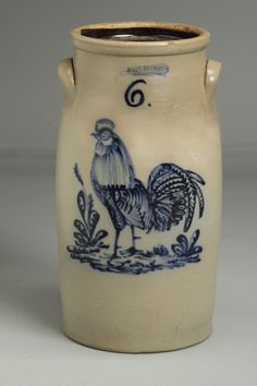 a blue and white vase with a rooster on it