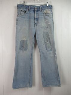 "Vintage 1970s faded denim pants, workwear. Lovingly patched and repaired over the years. Made by Sears Roebucks. Five pocket design. Zip fly. Actual measurements are: 35.5\" at the waist 29.5\" inseam 40\" overall length In good repaired and faded condition. There is an unprepared area over the left back pocket(photo)." Vintage Washed Blue Flare Jeans With Pockets, Retro Ripped Cotton Jeans, Ripped Vintage Jeans In Recycled Denim, Vintage Ripped Jeans In Recycled Denim, Reworked Light Wash Cotton Jeans, Vintage Washed Rigid Denim Jeans, Vintage Washed Blue Recycled Denim Bottoms, Vintage Flare Jeans In Medium Wash Recycled Denim, Retro Distressed Cotton Jeans