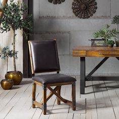 a chair sitting in front of a wooden table with potted plants on top of it