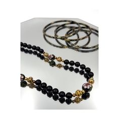 Vintage Black and Gold Cloisonné 29" Beaded Necklace and Bangle Set. Heavy Black Glass Beads with Beautifully Crafted Cloisonné Beads Throughout. Comes with 3 Matching Black and Gold Bangle Bracelets. Lovely Enamel Work with Pink, Blue, Green, Red, Black and Gold Colors. These are High Quality Pieces made with stunning Artisan craftsmanship. Necklace is 29 inches long (approx. chest length for most). Bangle Bracelet openings are 2 1/2 Inches wide. Fishhook Clasp Marked Silver on Necklace. Slight Bohemian Single Strand Jewelry For Wedding, Bohemian Single Strand Wedding Jewelry, Traditional Black Party Bracelets, Traditional Black Bracelets For Party, Elegant Hand-strung Multi-strand Jewelry, Formal Multi-strand Black Bead Jewelry, Multi-strand Beaded Chain Jewelry For Wedding, Elegant Beaded Chain Wedding Bracelet, Traditional Single Strand Jewelry For Wedding