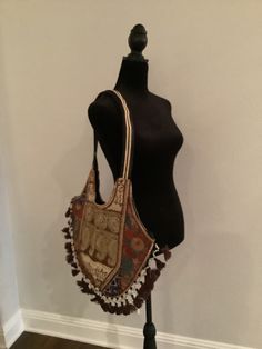 "Boho shoulder bag. Cotton bag with shear material on outside that is embroidered. Colors are brown, gold, and touches of deep blue and peach.  The opposite side is similar but also has some touches of red and green embroidery.  Unique and elegant piece. 15\" height, 18\" length" Travel Embroidered Beige Shoulder Bag, Embroidered Beige Shoulder Bag For Travel, Brown Bohemian Handheld Satchel, Bohemian Brown Handheld Satchel, Traditional Brown Rectangular Shoulder Bag, Traditional Brown Tote Bag, Embroidered Beige Tote Shoulder Bag, Brown Embroidered Satchel For Travel, Multicolor Embroidered Shoulder Bag With Adjustable Strap