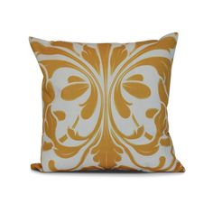 a yellow and white pillow with an ornate design on the front, sitting against a white background