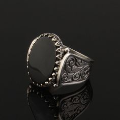 Flat Onyx Silver Men Ring. Handmade in 925 sterling silver with onyx stone. On the ring Oval black agate - aqeeq, onyx stone settled. Sides has elegance ornaments. Dimensions of stone is 15 mm x 20 mm. Average weight of Flat Onyx Silver Men Ring is 14 gr. (depends your ring size). Back side is open to touch your skin. Classic and exclusive style. Stone Type: Agate - Aqeeq, Onyx Stone Color: Black Stone Dimensions: 15 mm x 20 mm Stone Shape: Oval, Flat Average Weight: 14 gr. Made in Istanbul, Tur Silver Onyx Signet Ring Luxury Style, Luxury Silver Onyx Signet Ring, Luxury Silver Signet Ring With Onyx, Luxury Black Engraved Ring With Polished Finish, Luxury Black Engraved Ring In Sterling Silver, Black Sterling Silver Engraved Ring, Silver Onyx Signet Ring With Polished Finish, Black Sterling Silver Hallmarked Engraved Ring, Black Sterling Silver Signet Ring With Polished Finish