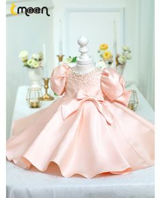 a pink dress sitting on top of a table