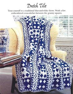 a blue and white afghan sitting on top of a chair next to a book cover