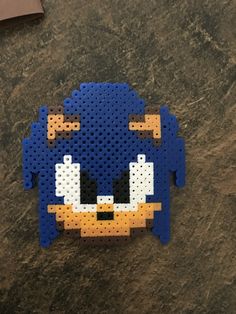 a perler bead sonic the hedgehog is laying on top of a table