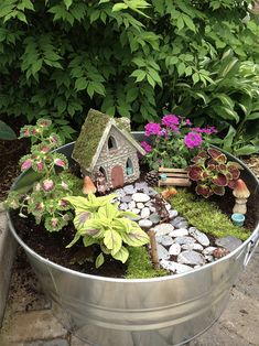 a metal tub filled with lots of plants and rocks