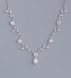 a necklace with pearls and leaves on it