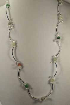 This single strand necklace is made up of silver plated tube beads strung between sets of clear glass nuggets sandwiching colored round beads.  The colored rounds include mint green, pale yellow/green, and tan/brown.  The necklace is finished with a lobster clasp.  I made two of these necklaces in different lengths, and the last picture shows the two necklaces layered together. The necklace is approximately 29.5 inches in length. The necklace is packaged in an anti-tarnish bag and shipped in a p Necklaces Layered, Two Necklaces, Tube Necklace, Angel Earrings, Bracelet Craft Diy, Chain Maille Jewelry, The Last Picture Show, Rose Gold Heart, Heart Dangle Earrings