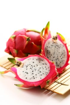 the dragon fruit is cut in half and ready to be picked from the bushel