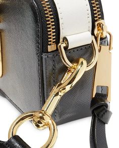 The Marc Jacobs Snapshot bag: Versatile mini bag for all your Instagram moments. Adjustable straps and spacious interior allow carrying essentials from sunup to sundown – perfect for poolside, brunch and parties. Two zip compartments keep your phone, makeup and more organized throughout the day. Luxury Crossbody Bag Strap With Gold-tone Hardware, Rectangular Camera Bag With Branded Hardware For Travel, Modern Bags With Metal Hardware For On-the-go, Luxury Travel Camera Bag With Branded Hardware, Modern Satchel Bag Strap With Detachable Feature, Luxury Shoulder Camera Bag With Zipper Closure, Modern Camera Bag With Gold-tone Hardware For Everyday Use, Modern Travel Camera Bag With Gold-tone Hardware, Modern Bag Strap With Detachable Feature For On-the-go