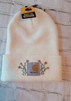 a white beanie hat with a patch on it