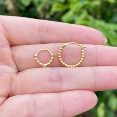 ✨Gold Beads Huggie Earrings✨ S925 Sterling Silver(Base) 18K Yellow Gold(Plated) 10mm diameter (Small Size) 16mm diameter (Medium Size) 🎁Earrings come in beautiful gift boxes. ✔Please Check Before Purchase The Earrings are 18K gold plated and have S925 Silver inside. People with skin sensitivity to specific metals should check before purchase. The lock might get bent out if got caught on clothes, blankets, hair. Please gently straighten it by hand. Gold jewelry is beautiful yet fragile and can s Yellow Gold Beaded Hoop Earrings For Gift, Hypoallergenic Round Gold-plated Cartilage Earrings, Gold Hypoallergenic Round Bead Earrings, Gold Hypoallergenic Earrings With Round Beads, Dainty Gold Hoop Earrings With Round Beads, Gold Hypoallergenic Earrings, Dainty Nickel-free Round Bead Earrings, Dainty Nickel-free Earrings With Round Beads, Nickel-free Yellow Gold Round Bead Earrings