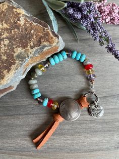 This is a very pretty boho style bracelet. This bracelet features turquoise, labradorite, aura quartz, red jade and yellow fluorite. The clasp is made with a real Indian head nickel and leather. 7"  #beadedartbyv #beadedearrings #beadedjewelry #HandCraftedJewelry #artisanjewelry #artisanmade #bohostyle Handmade Labradorite Bohemian Bracelets, One Of A Kind Bohemian Beaded Bracelets For Festival, One-of-a-kind Bohemian Beaded Bracelet For Festivals, Bohemian Turquoise Bracelet, Bohemian Labradorite Beaded Bracelets With Gemstone Beads, Bohemian Bracelets With Labradorite And Natural Stones, Bohemian Labradorite Gemstone Beaded Bracelets, One-of-a-kind Bohemian Beaded Bracelets For Festivals, Bohemian Labradorite Healing Bracelet