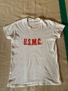 Unique USMC Howitzer Battery t shirt. 100 % cotton, single stitch, tube knit. Vintage style sleeves. A few condition issues shown in photos. Size marked large but please refer to the actual measurements: 19 inches from pit to pit measured lying flat, 17 inches across the shoulders, overall length is 27 inches. Vintage Cotton Crew T-shirt, Vintage Cotton Crew Neck T-shirt, Retro Cotton Crew Top, Screen Print Cotton Crew Neck Top, Retro Crew Neck Pre-shrunk Top, Retro Cotton Crew Neck T-shirt, Vintage Cotton Crew Neck Top, Vintage Crew Neck Shirt With Logo Print, Vintage Crew Neck Graphic Print Top