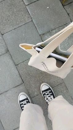 a person standing next to a bag on the ground