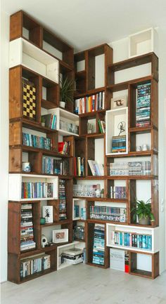 a bookshelf filled with lots of books next to a wall full of shelves