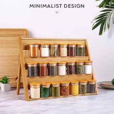 a wooden spice rack filled with spices next to a potted plant and cutting board