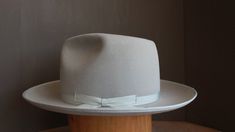 Handcrafted fedora inspired by the hat worn by Jeff Bridges in Seabiscuit Originally custom made by Baron Hats Custom made to order, please allow 8-12 weeks for delivery. Store credit or exchange only. Crown Front: 5-1/4" Crown Back: 4-3/4" Brim: 3" Color: Silverbelly Hatband: 1" matching silver grosgrain ribbon and binding * Disclaimer: "Seabiscuit", is TM and © (or copyright) by DreamWorks Pictures, Spyglass Entertainment, The Kennedy/Marshall Company, and Larger Than Life Productions. Any rep