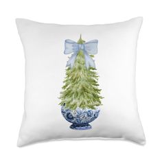 a blue and white pillow with a christmas tree on it's side, in front of a white background