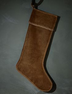 a brown suede stocking hanging on a wall