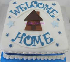 a welcome home cake with stars and a house on it's side that says, welcome home