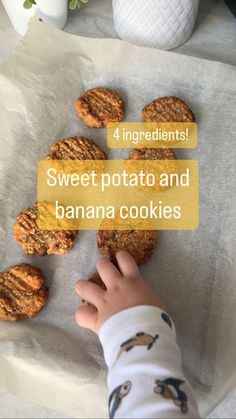 a little kid reaching for some cookies on top of a sheet of paper with the words sweet potato and banana cookies